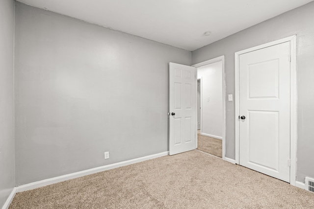 unfurnished bedroom with light colored carpet