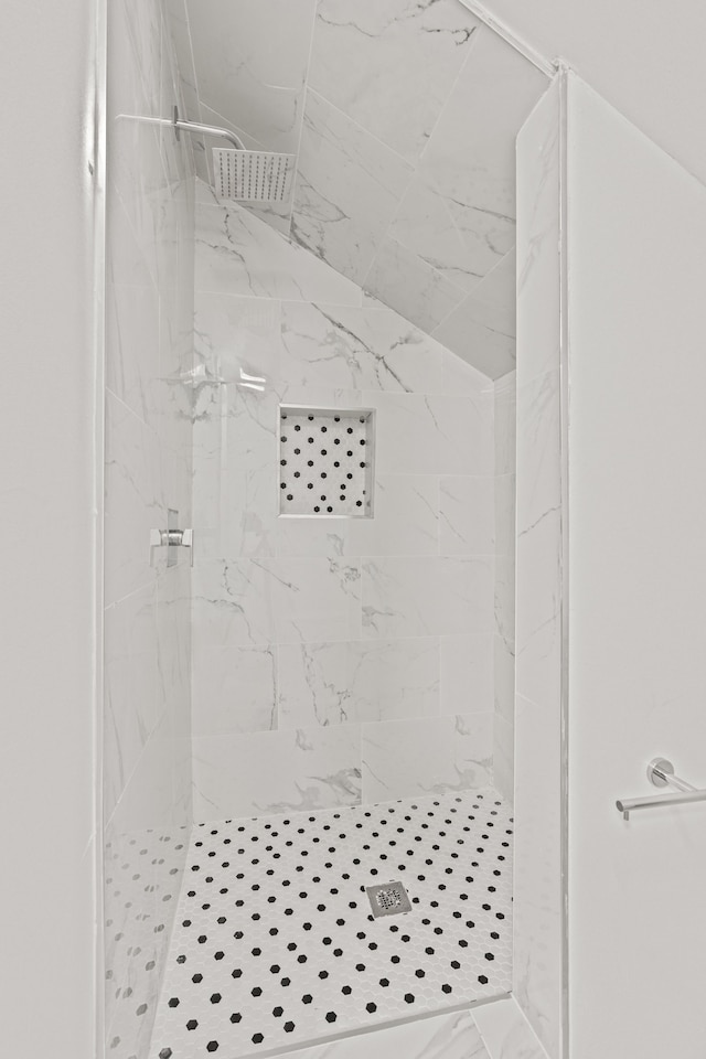 bathroom with a tile shower