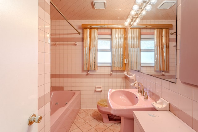 full bathroom featuring washtub / shower combination, plenty of natural light, and tile walls