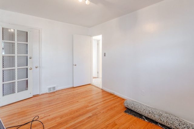 unfurnished room featuring hardwood / wood-style floors