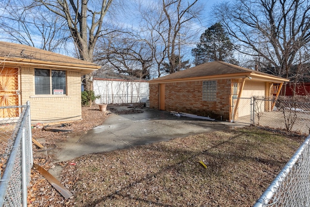 view of side of home featuring a garage and an outdoor structure