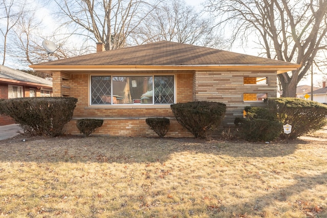 view of side of home with a yard