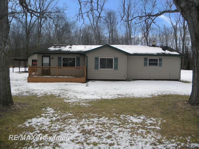 view of snow covered back of property