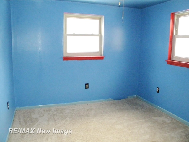 spare room featuring light colored carpet