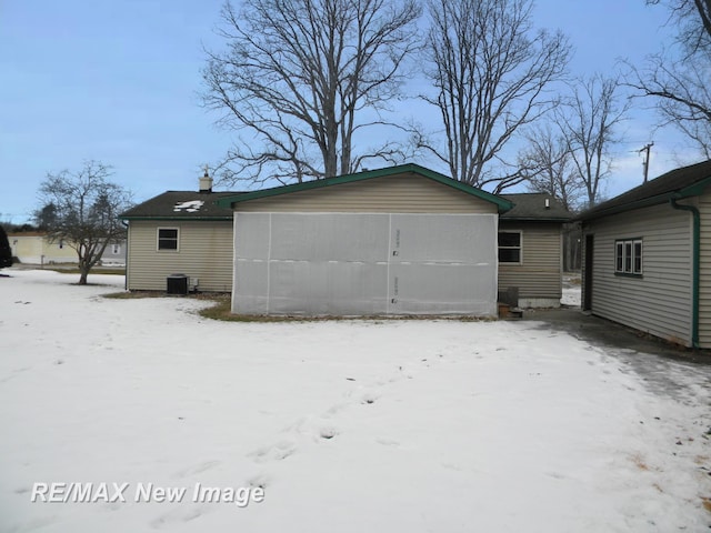 view of snow covered rear of property