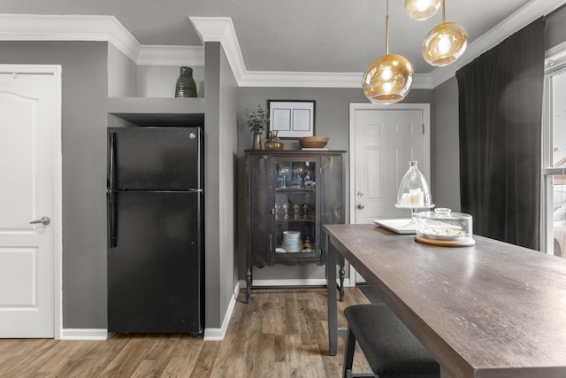 dining area featuring crown molding and wood-type flooring