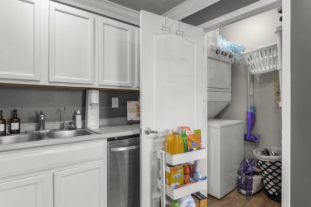 laundry room featuring stacked washing maching and dryer, sink, and dark hardwood / wood-style floors