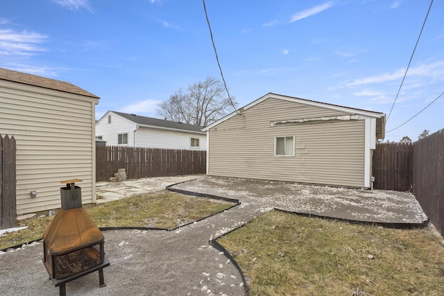 back of house featuring a patio and an outdoor fire pit