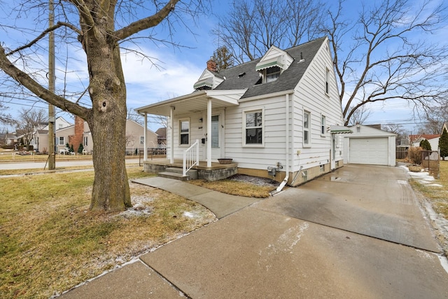 view of front of property featuring a garage and an outdoor structure