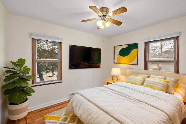 bedroom featuring hardwood / wood-style flooring and ceiling fan