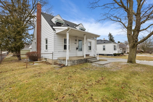 bungalow-style house featuring a front lawn