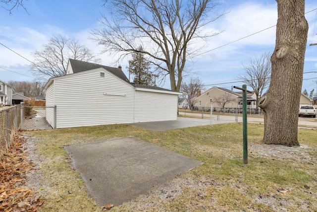 view of property exterior with a yard and a patio