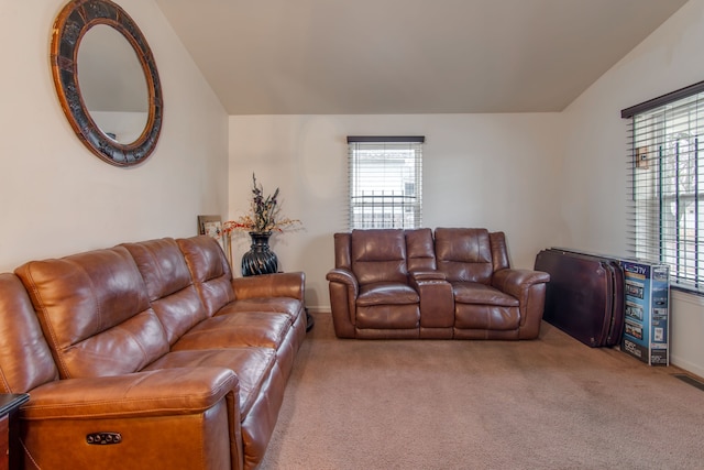 carpeted living room featuring lofted ceiling