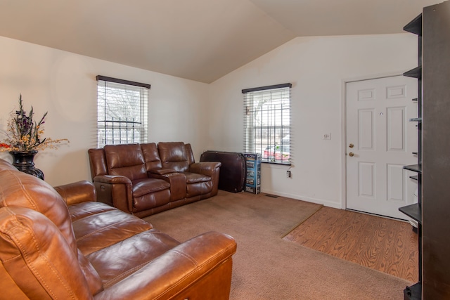 living room with plenty of natural light, carpet flooring, and vaulted ceiling