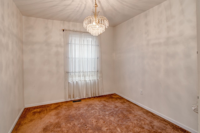 unfurnished room featuring an inviting chandelier and carpet flooring