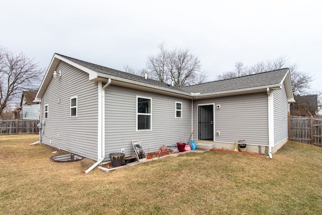 rear view of house featuring a yard