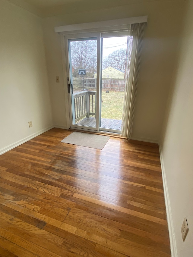 empty room with dark hardwood / wood-style floors