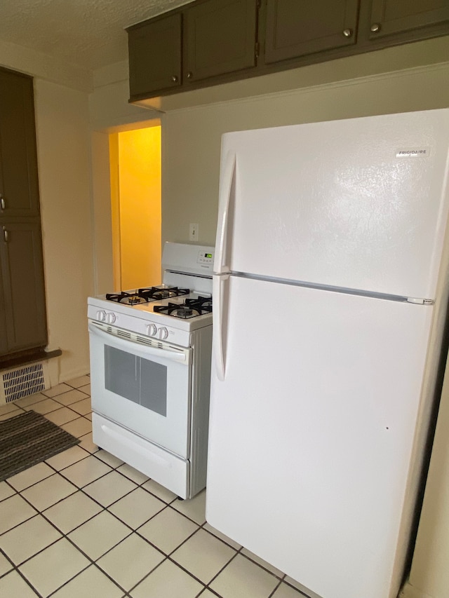 kitchen with white appliances and light tile patterned flooring