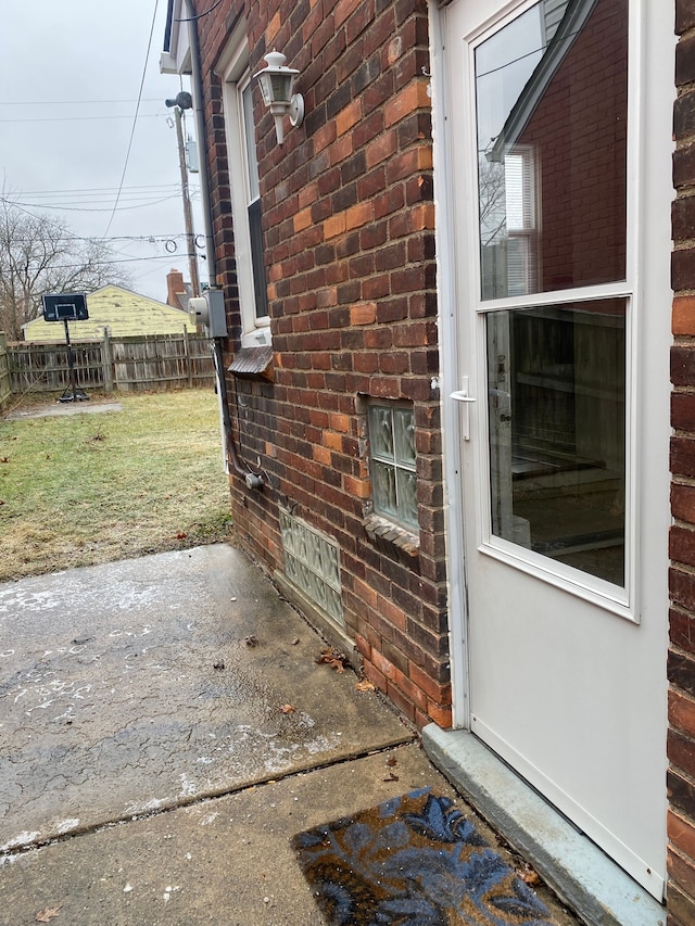 view of exterior entry featuring a patio area