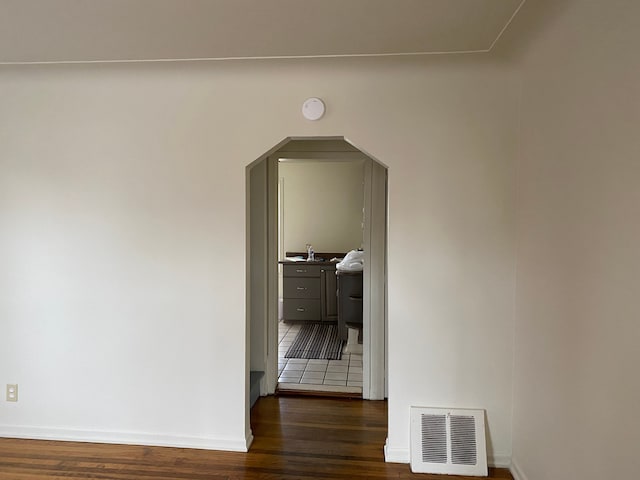 corridor with dark wood-type flooring