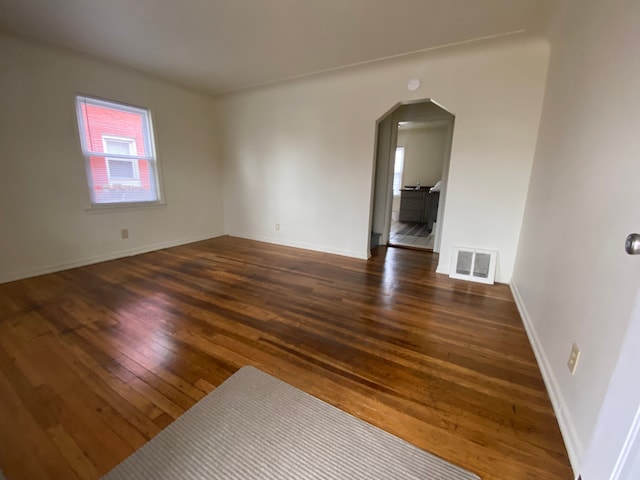 unfurnished room featuring dark hardwood / wood-style flooring