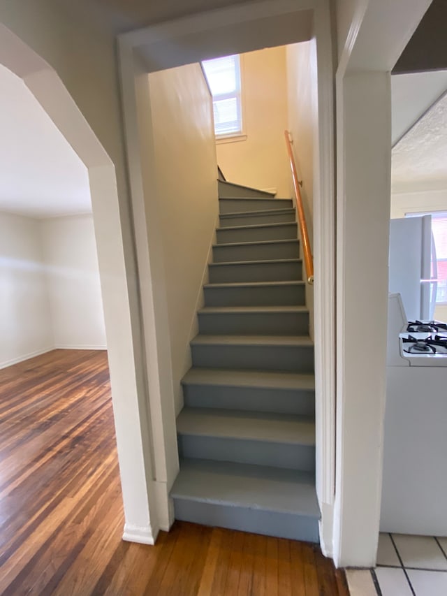 stairway featuring hardwood / wood-style flooring