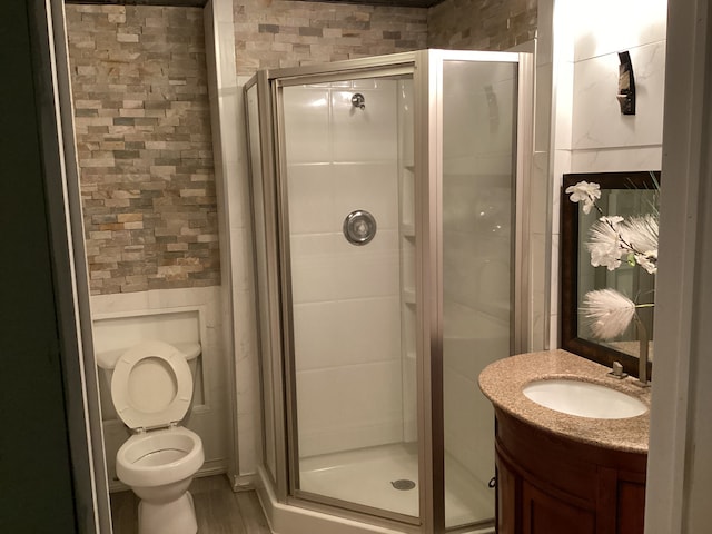 bathroom with vanity, toilet, and walk in shower