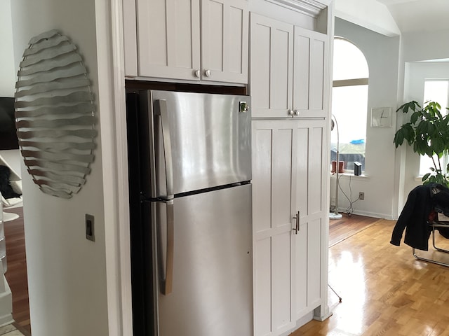 kitchen featuring white cabinetry, light hardwood / wood-style floors, and stainless steel refrigerator