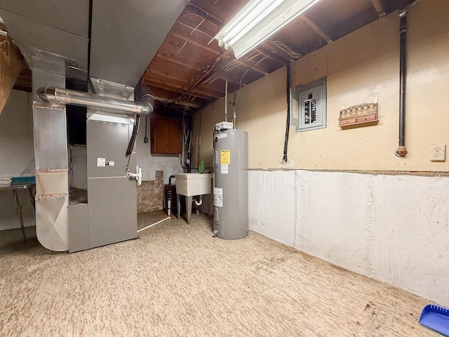 basement featuring heating unit, electric panel, sink, and water heater