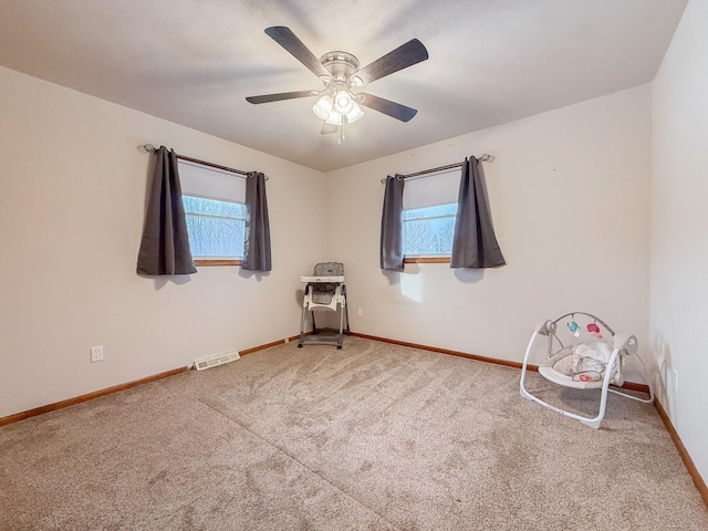 unfurnished room featuring ceiling fan and carpet flooring