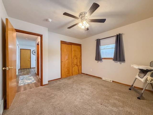 carpeted bedroom featuring a closet and ceiling fan