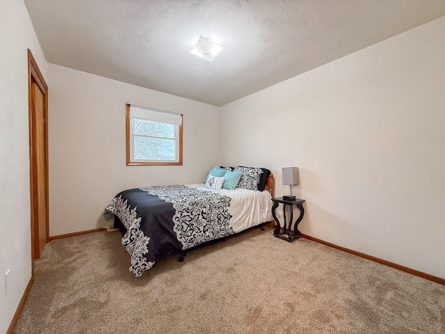 bedroom featuring carpet floors and a textured ceiling