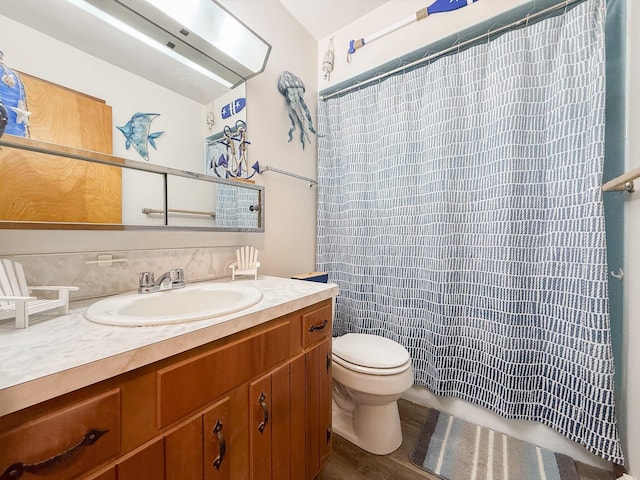 bathroom featuring vanity and toilet