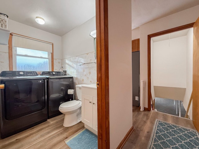 bathroom with wood-type flooring, separate washer and dryer, vanity, and toilet