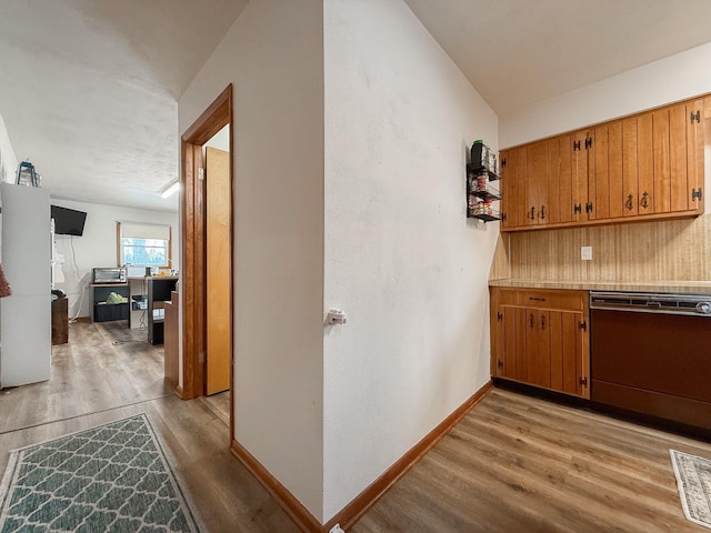 kitchen with light hardwood / wood-style floors and black dishwasher