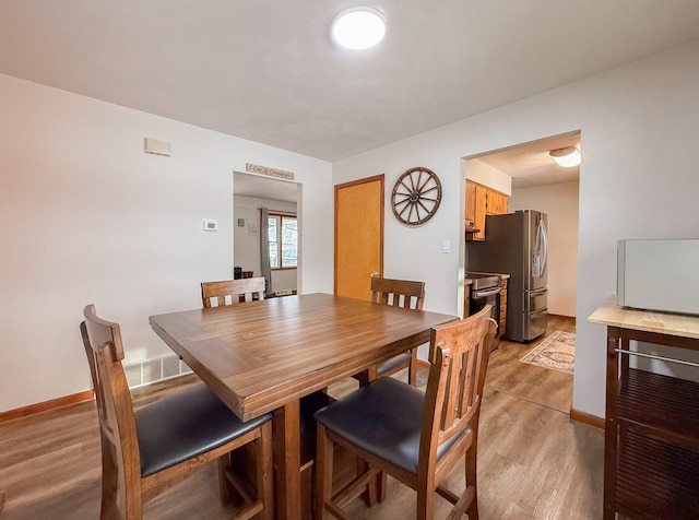 dining room featuring light hardwood / wood-style flooring