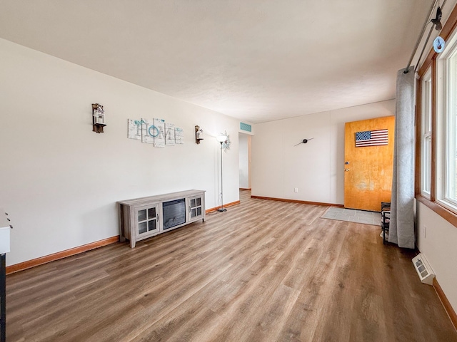 unfurnished living room with hardwood / wood-style flooring