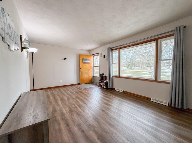 unfurnished living room with hardwood / wood-style floors