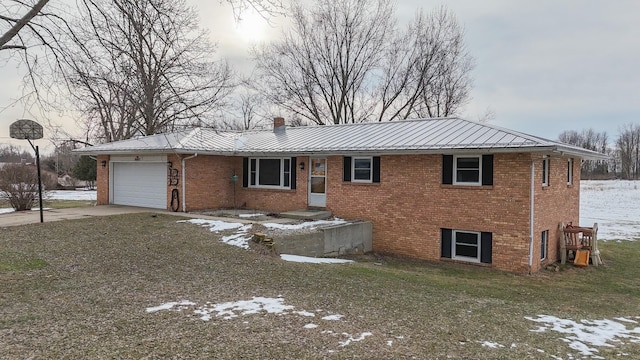 view of front of house featuring a garage and a lawn