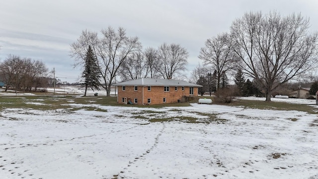 view of snow covered rear of property