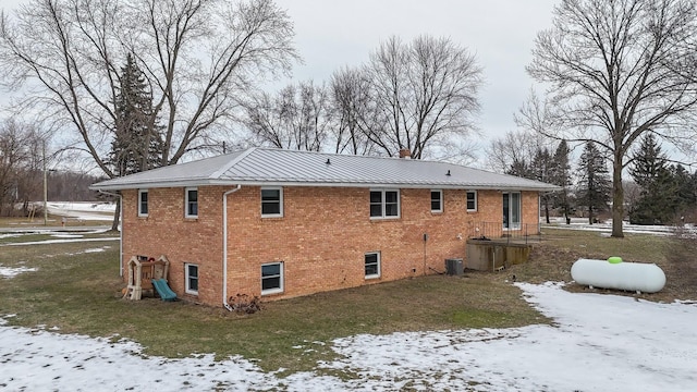 snow covered property featuring central AC unit