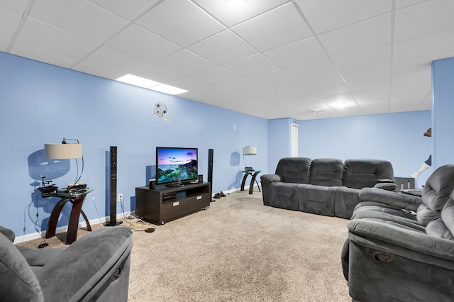 living room featuring a paneled ceiling and carpet floors