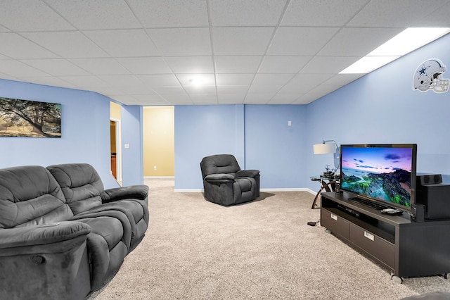 carpeted living room with a drop ceiling