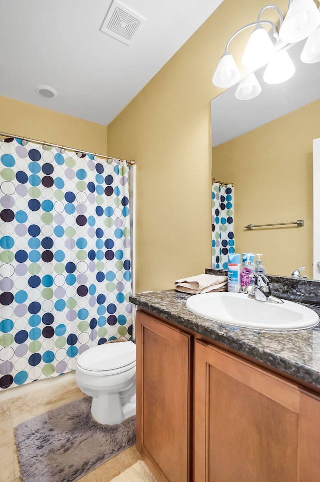 bathroom featuring toilet, vanity, tile patterned flooring, and a notable chandelier