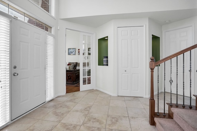 foyer entrance featuring french doors and light tile patterned floors