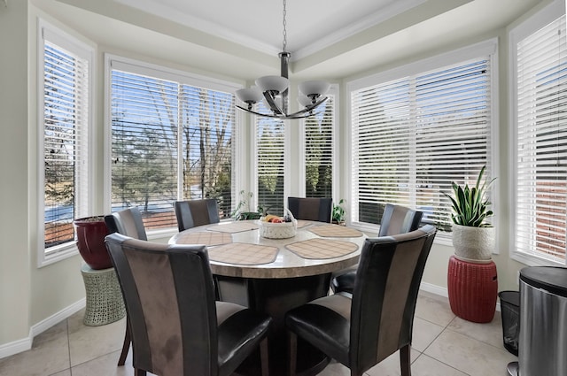 dining space with an inviting chandelier, light tile patterned floors, and ornamental molding