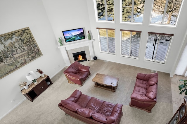 carpeted living room with a towering ceiling