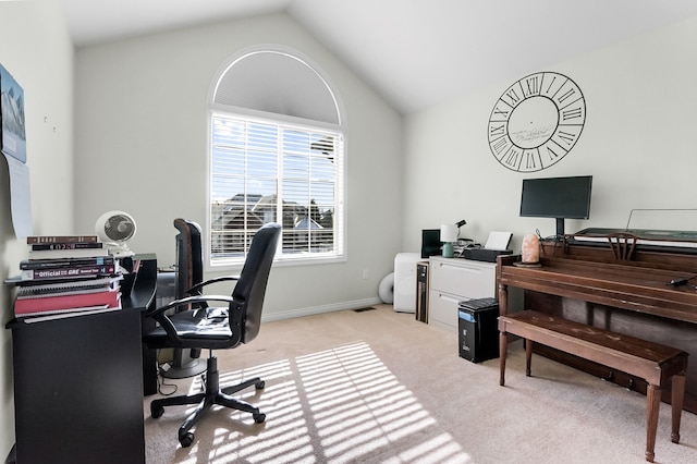 office area with vaulted ceiling and light colored carpet