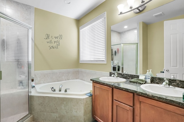 bathroom with independent shower and bath and vanity