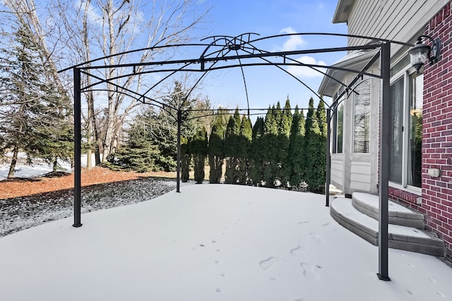 yard covered in snow with a patio